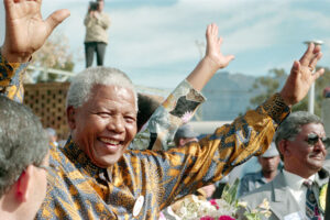 Nobel Laureate and former President of South Africa from 1994 to 1999 Nelson Mandela waves at his audience.
